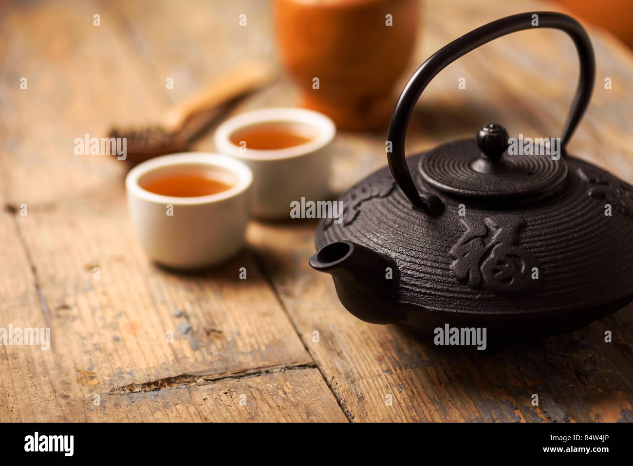 Traditional japanese herbal tea recipe prepared in cast iron teapot with organic dry herbs Stock