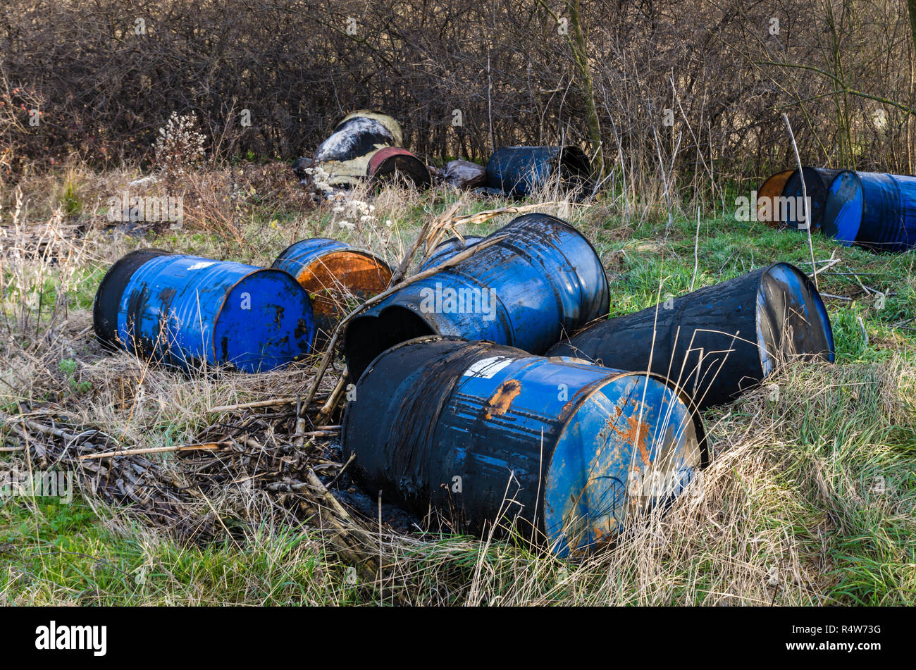 Barrels of toxic waste in nature, pollution of the environment. Stock Photo