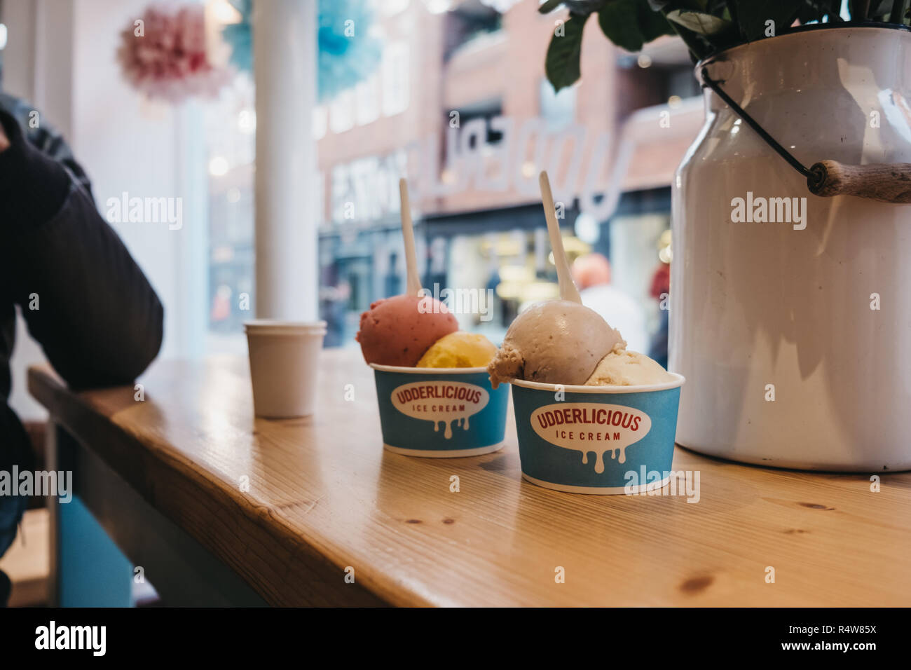 London, UK - November 21, 2018: Tubs of ice-cream on a table inside Udderlicious, an independent ice-cream parlour in Covent Garden, London, UK. Stock Photo