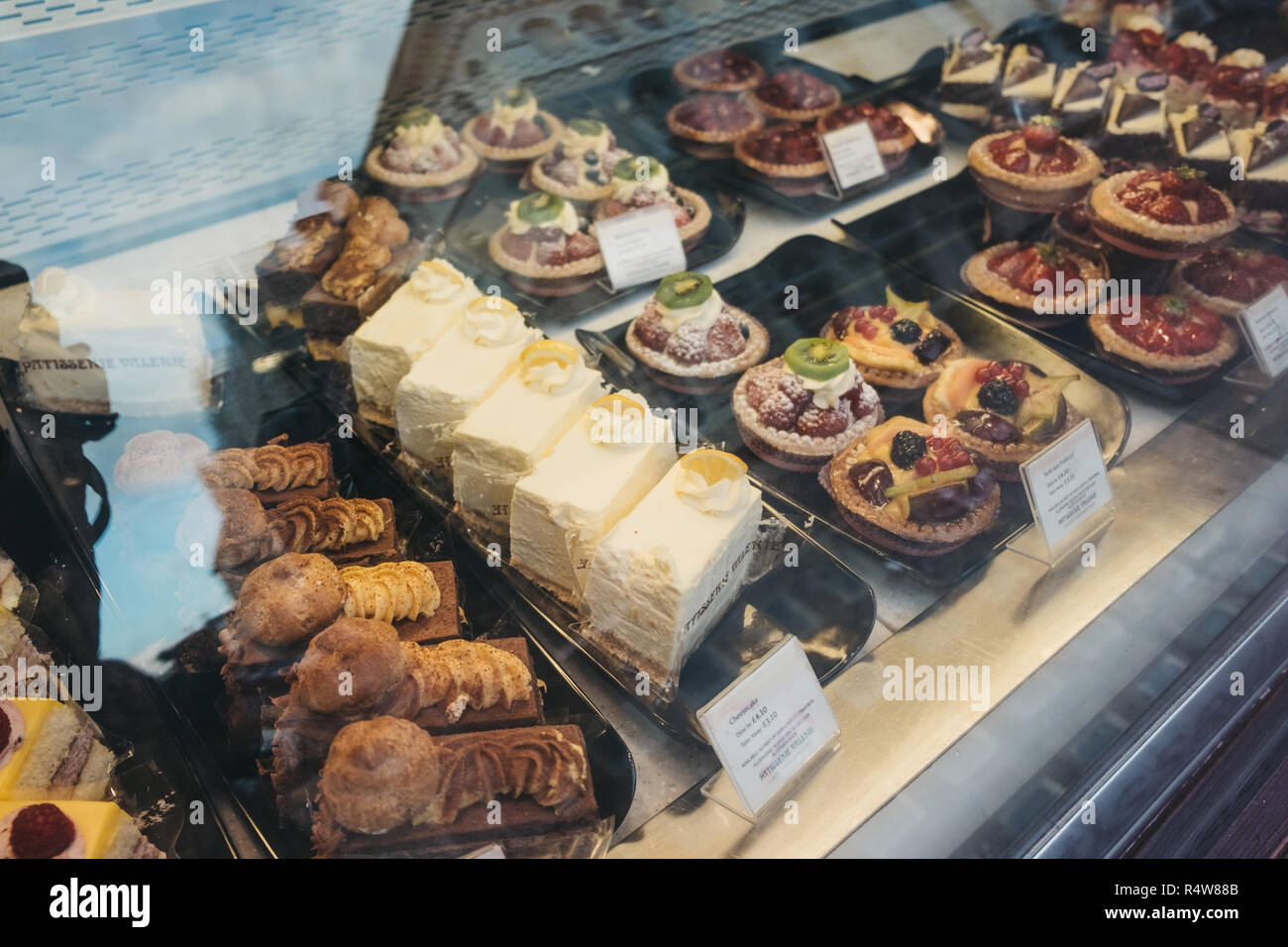 London, UK - November 21, 2018: Close up of cakes in the window display of Patisserie Valerie, a popular chain of coffee shops in London, UK. View fro Stock Photo