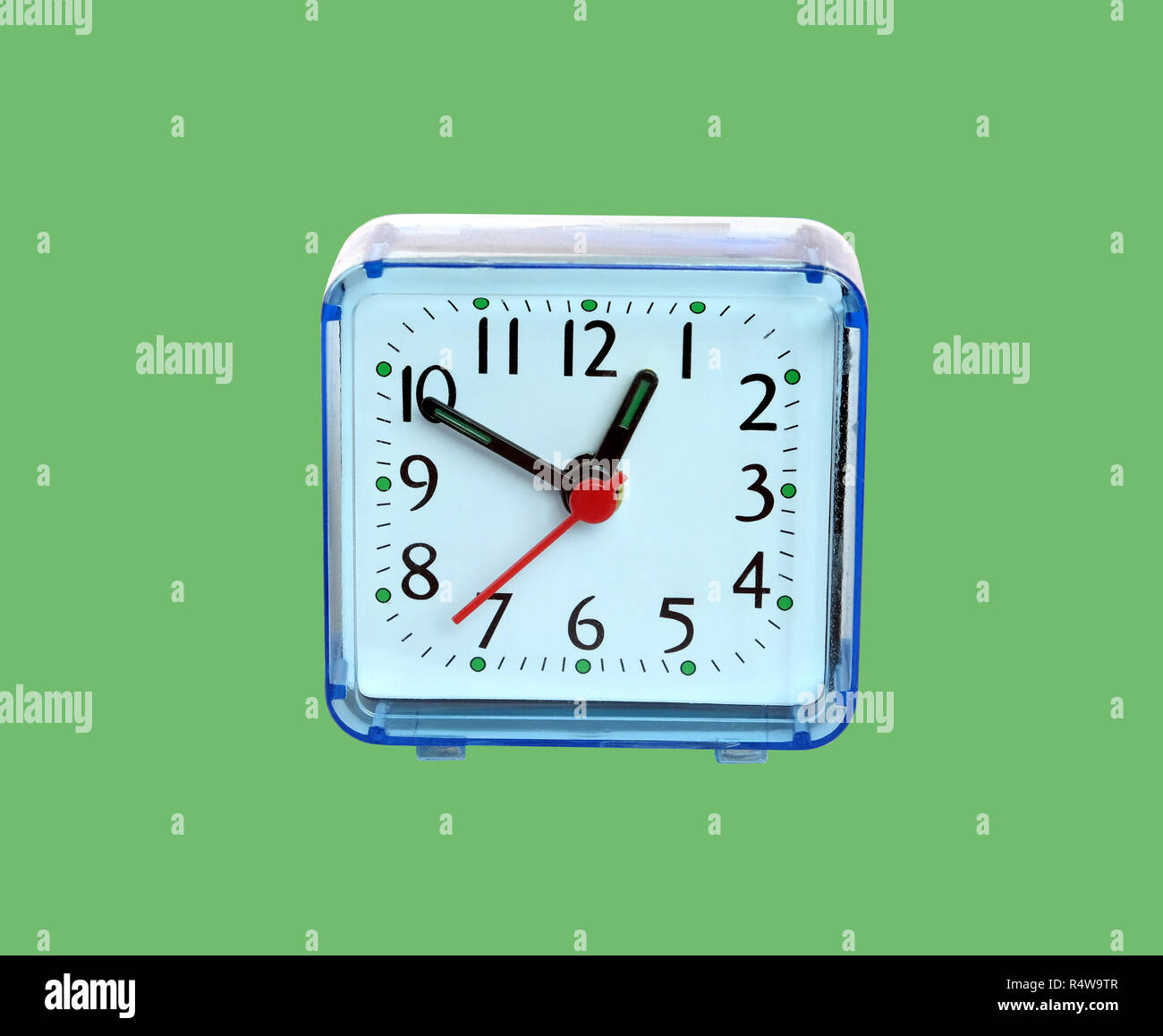 Table clock square shape showing one o'clock isolated on green background closeup Stock Photo