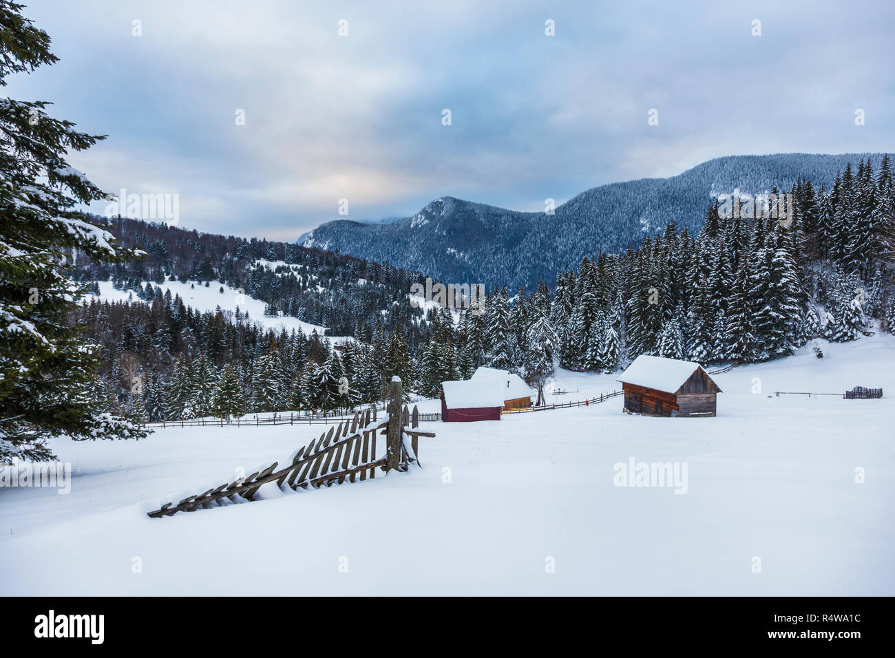 wooden house in a perfect snowy winter landscape. Snow covered rural ...