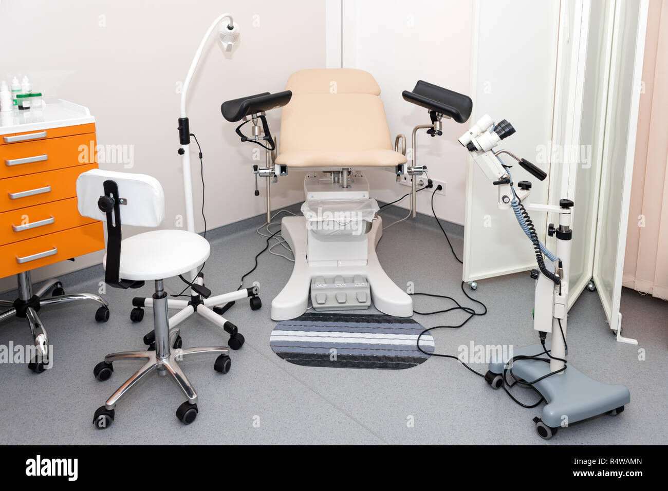 Gynecological cabinet with chair and other medical equipment in modern clinic. Equipment medicine, medical furniture, hospital, genicology, women's co Stock Photo