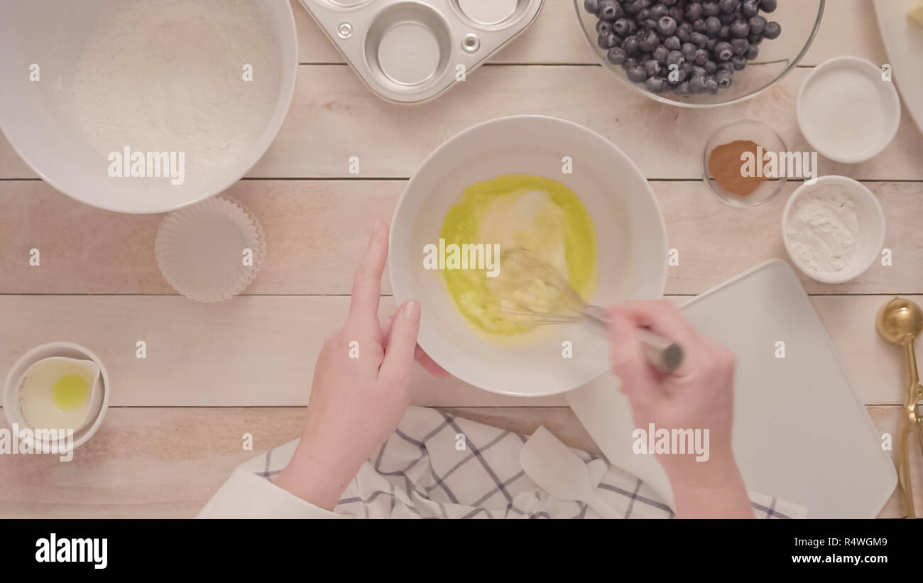 Mixing ingredients together in mixing bowl for blueberry muffins Stock