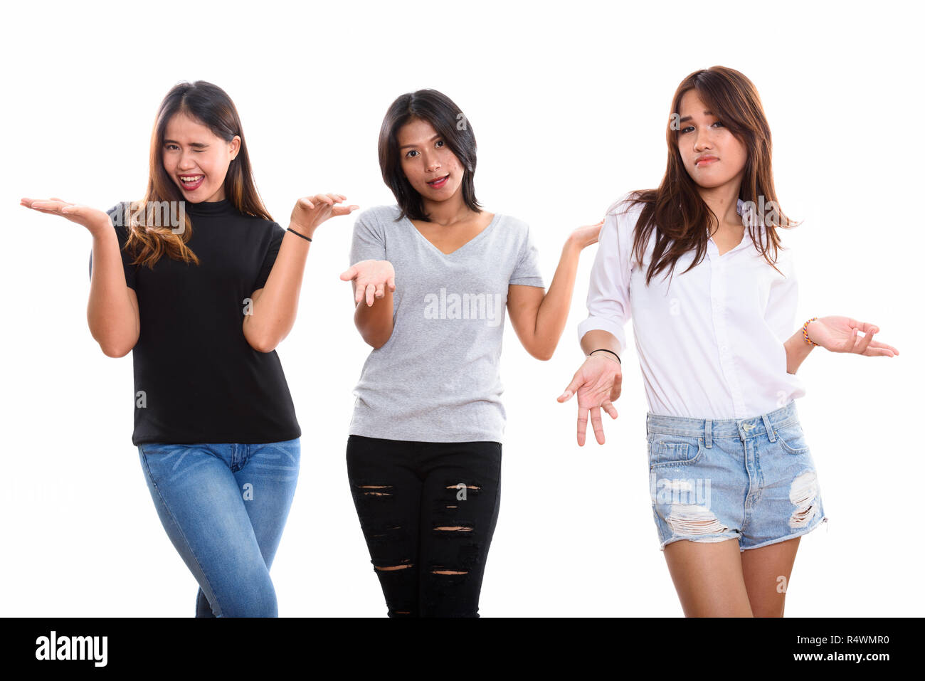 Studio shot of three young Asian woman friends looking confused Stock Photo