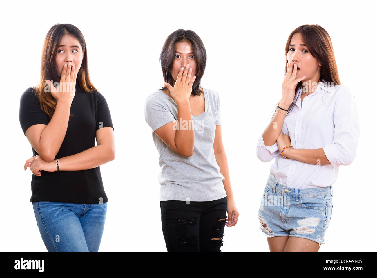 Studio shot of three young Asian woman friends looking shocked Stock Photo