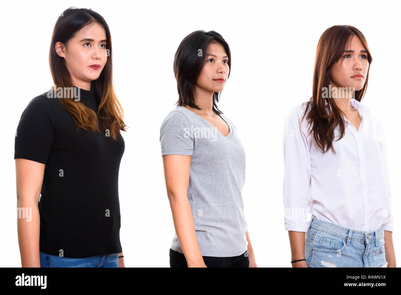 Studio shot of three young Asian woman friends thinking Stock Photo