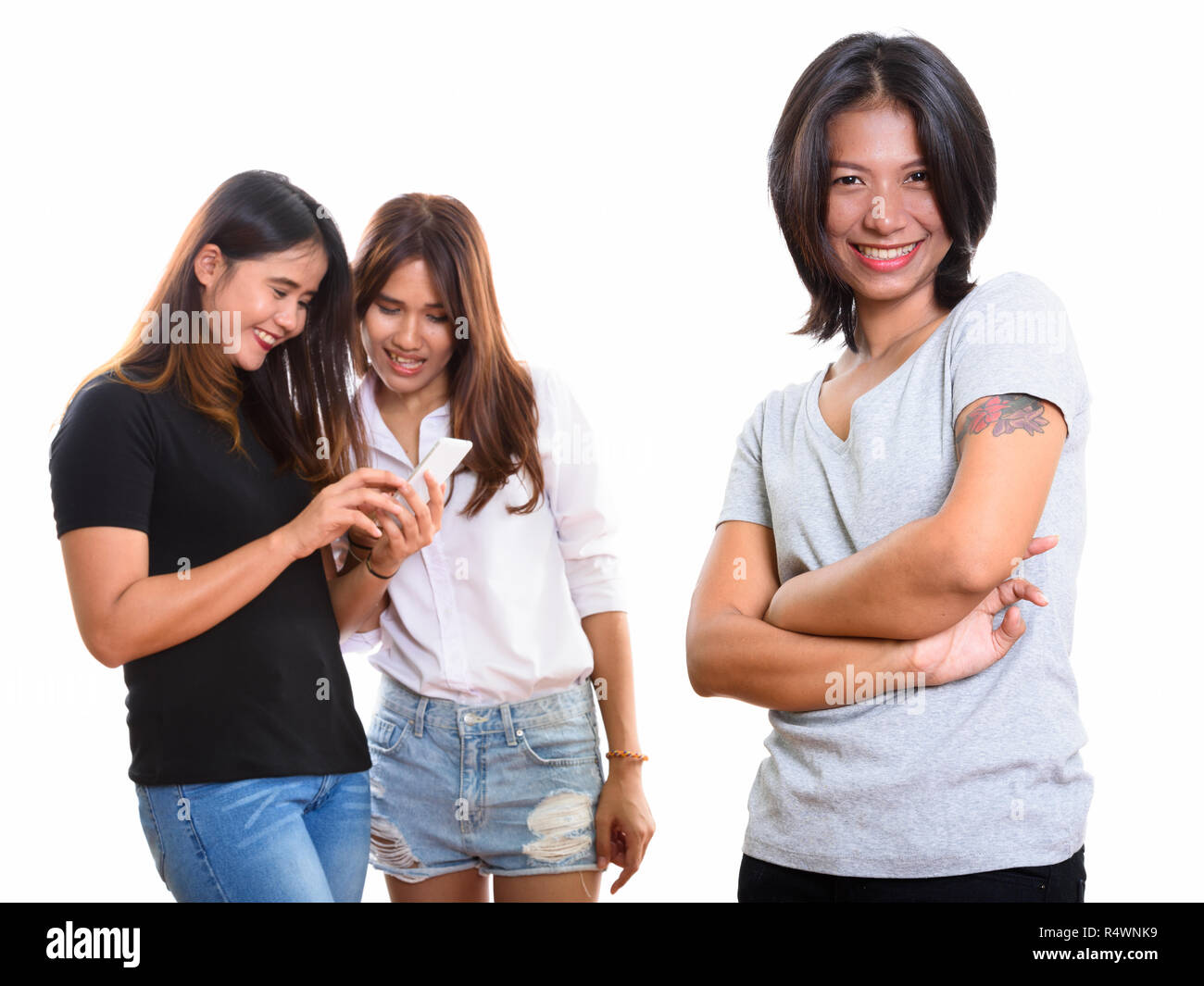 Young happy Asian woman smiling with arms crossed with two happy Stock ...