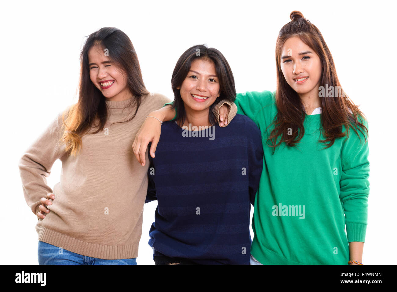 Studio shot of three happy young Asian woman friends smiling tog Stock Photo
