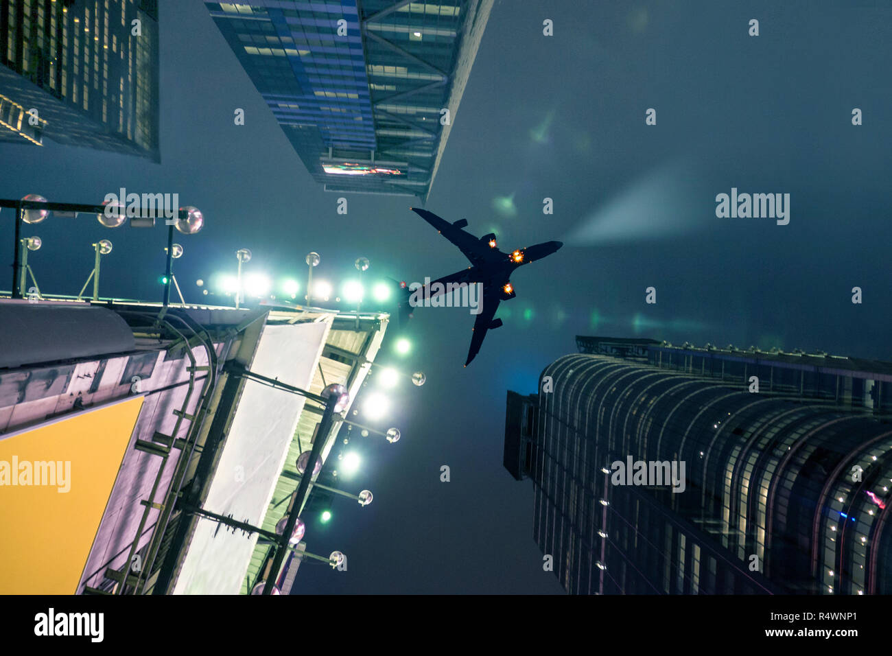Plane Flying Over New York Manhattan At Night With Dramatic Effect and Sky Scrapers and Billboard Lights. Stock Photo