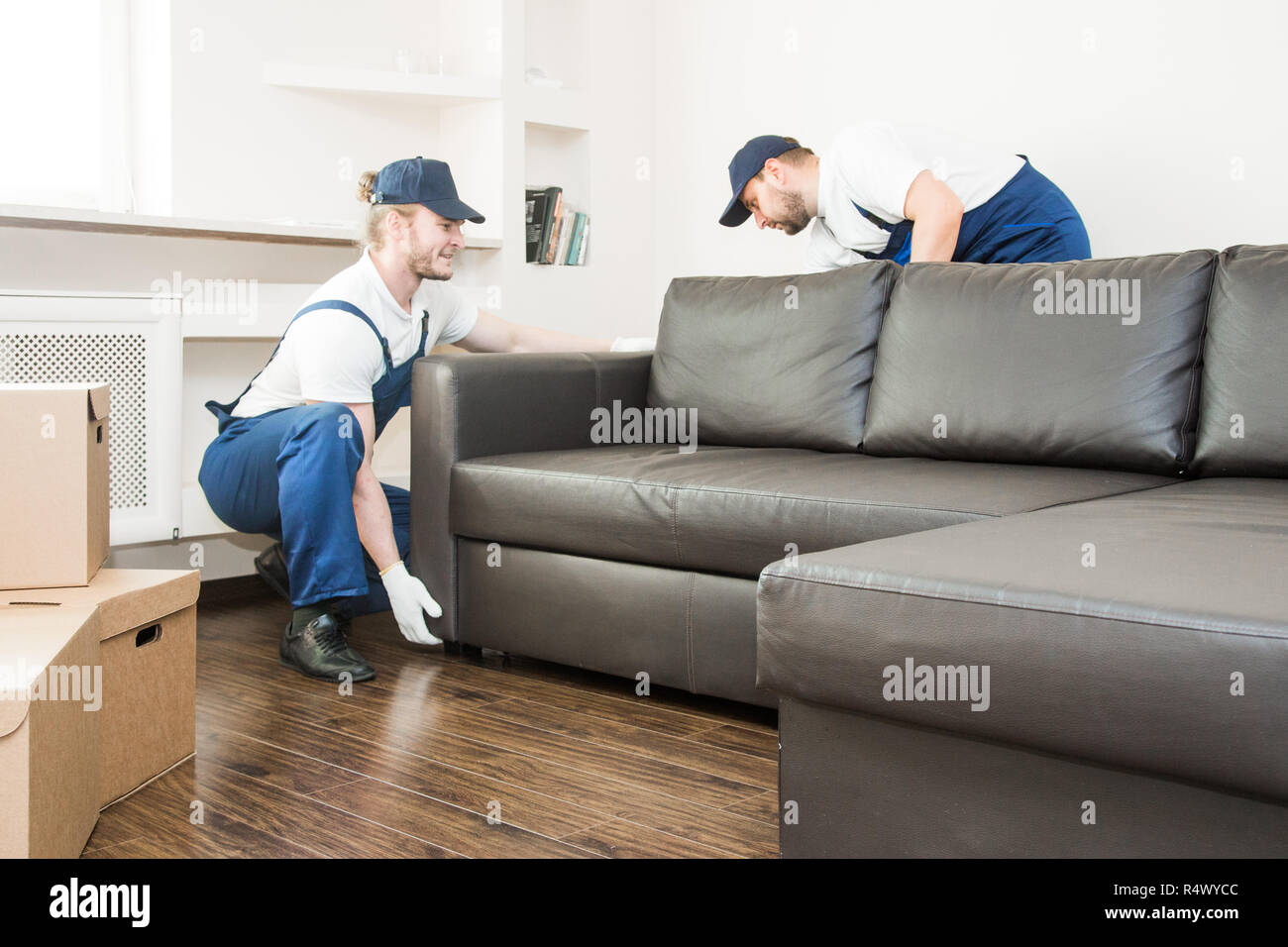 Delivery man move furniture carry sofa for moving to an apartment