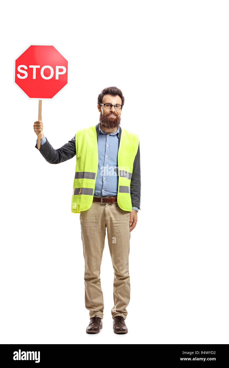 Full length portrait of a man with a safety vest holding a stop sign isolated on white background Stock Photo