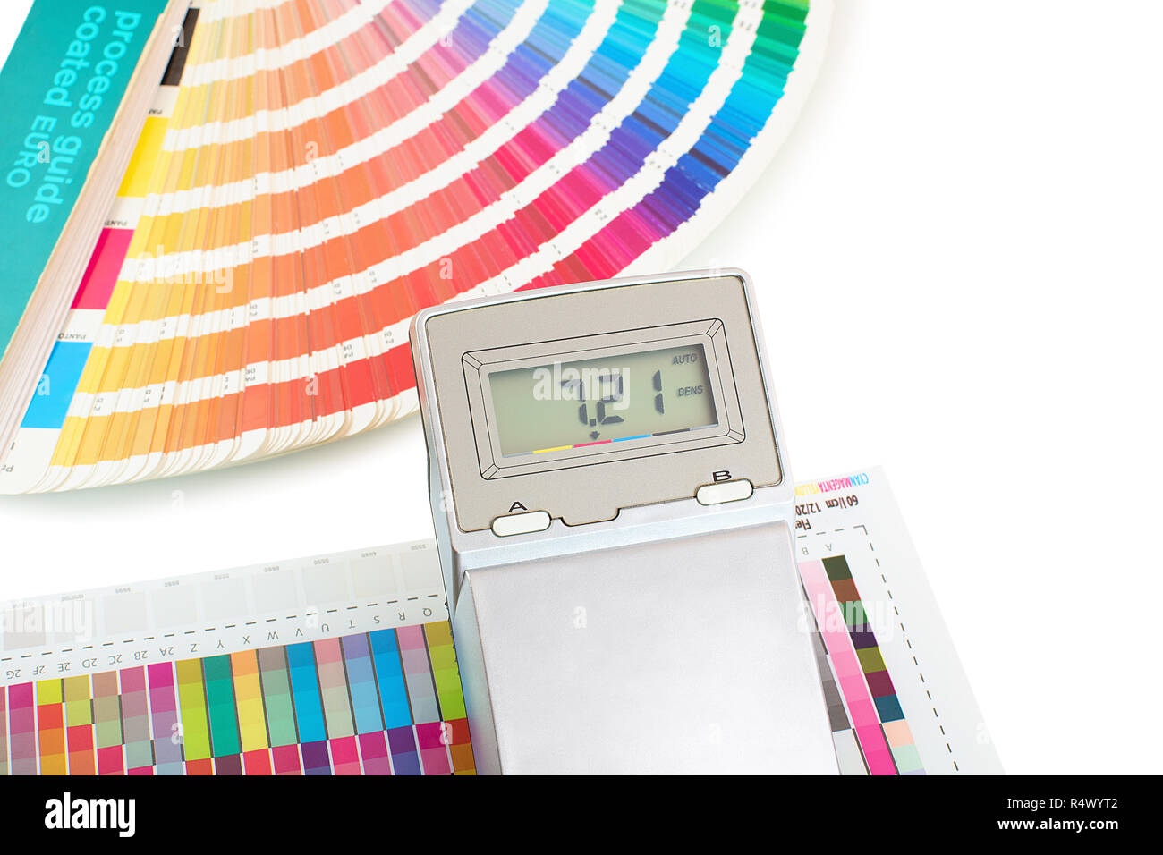Printed color swatch with density meter and paint guide isolated on white background. Color density check in printing process. Measuring color density Stock Photo