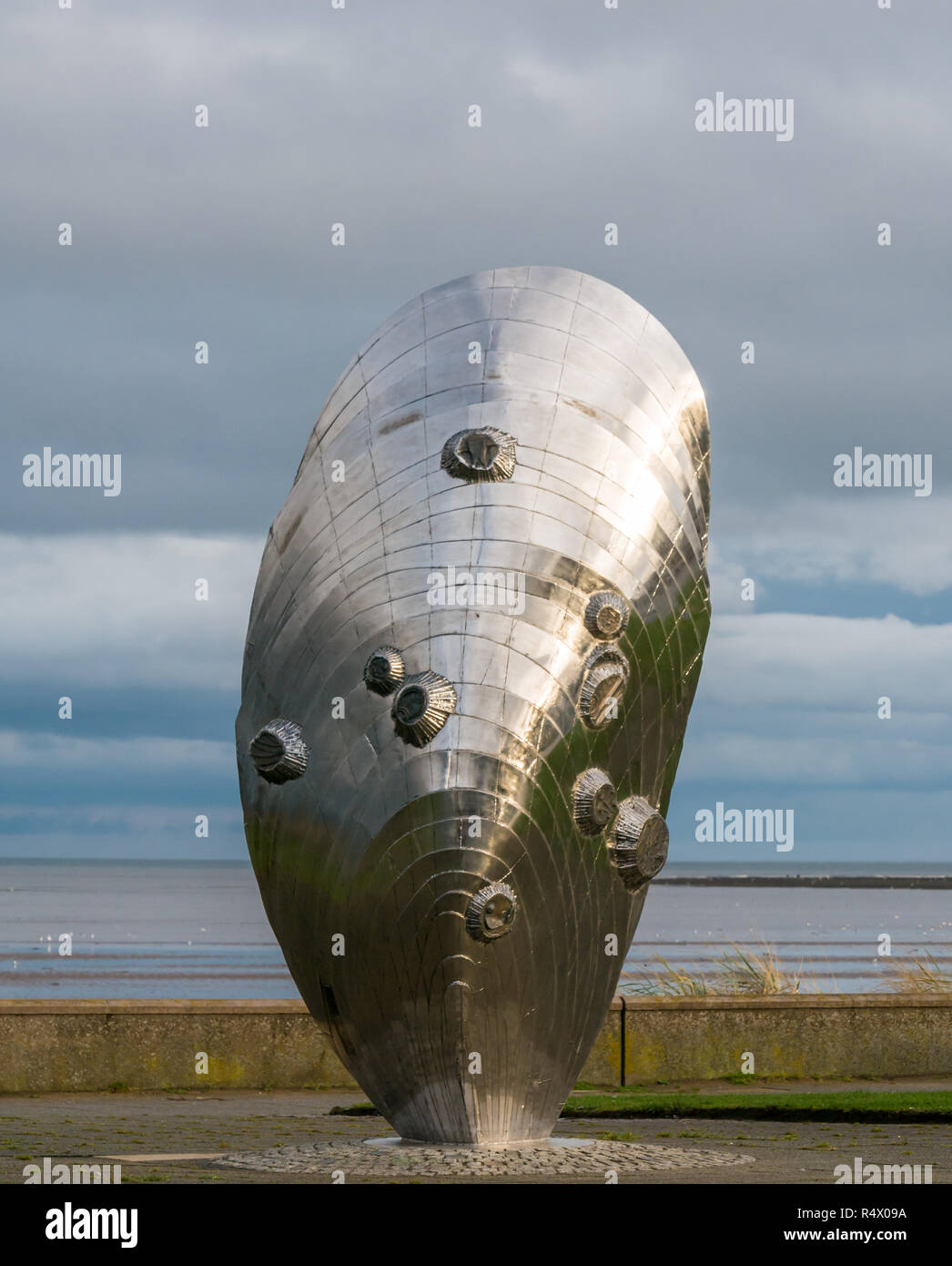 Stainless steel artwork sculpture by Michael Johnson called Memory and Reflection in mussel shell shape, Murdoch Green, Musselburgh, Scotland, UK Stock Photo