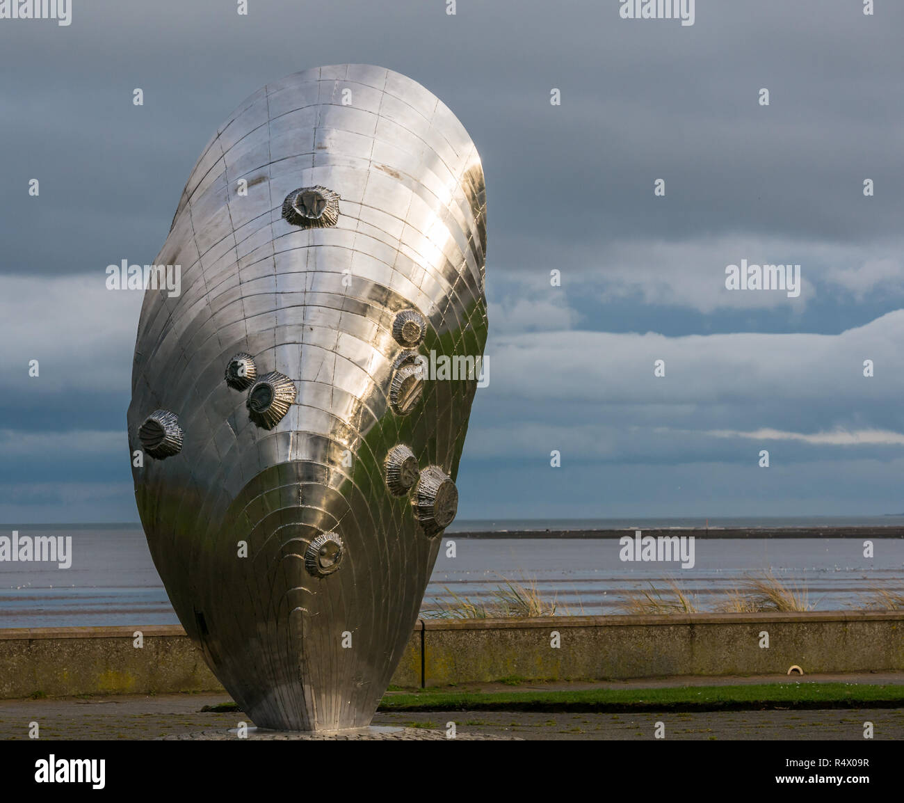 Stainless steel artwork sculpture by Michael Johnson called Memory and Reflection in mussel shell shape, Murdoch Green, Musselburgh, Scotland, UK Stock Photo