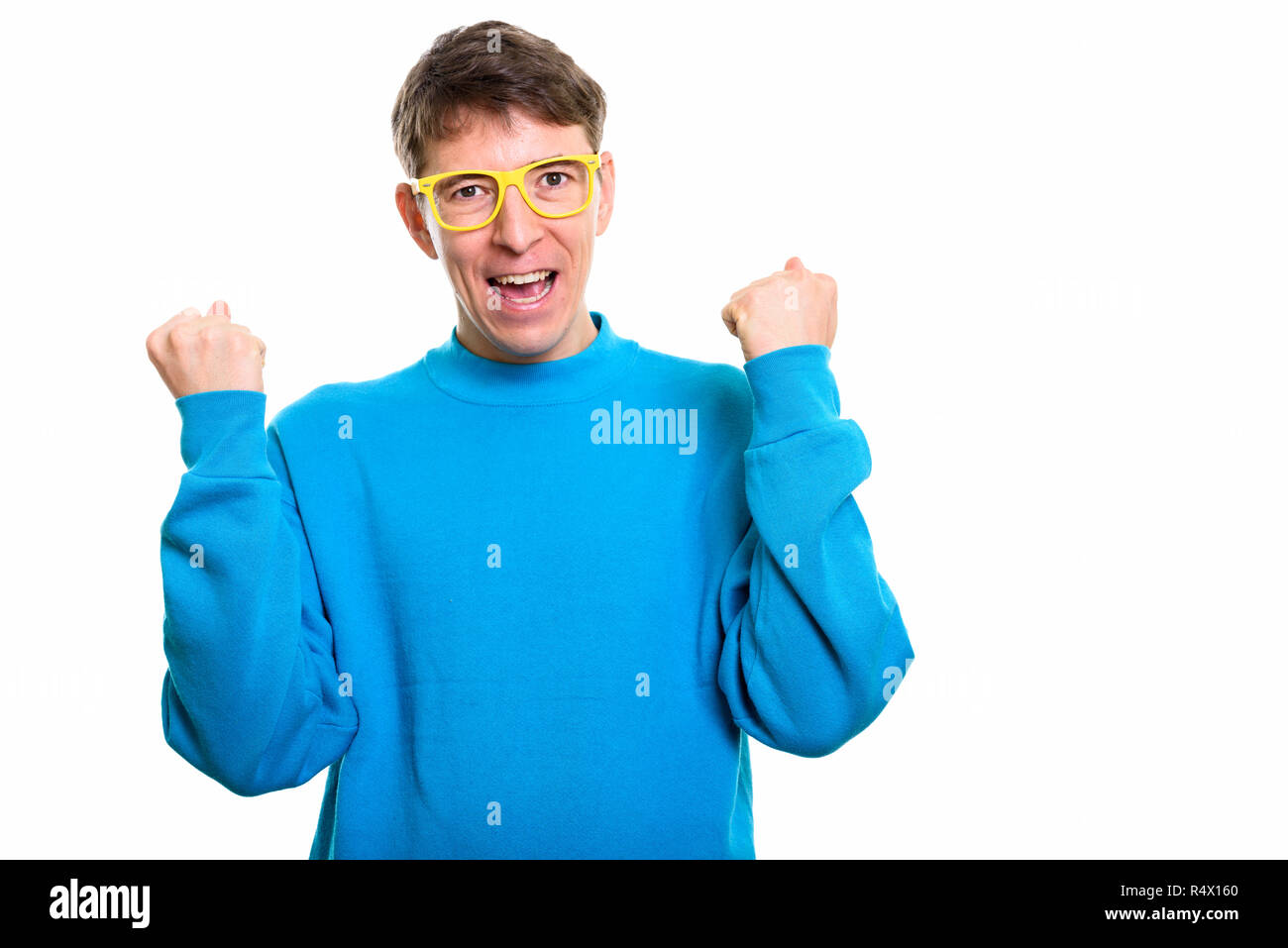 Studio shot of happy man smiling while looking excited with both Stock Photo