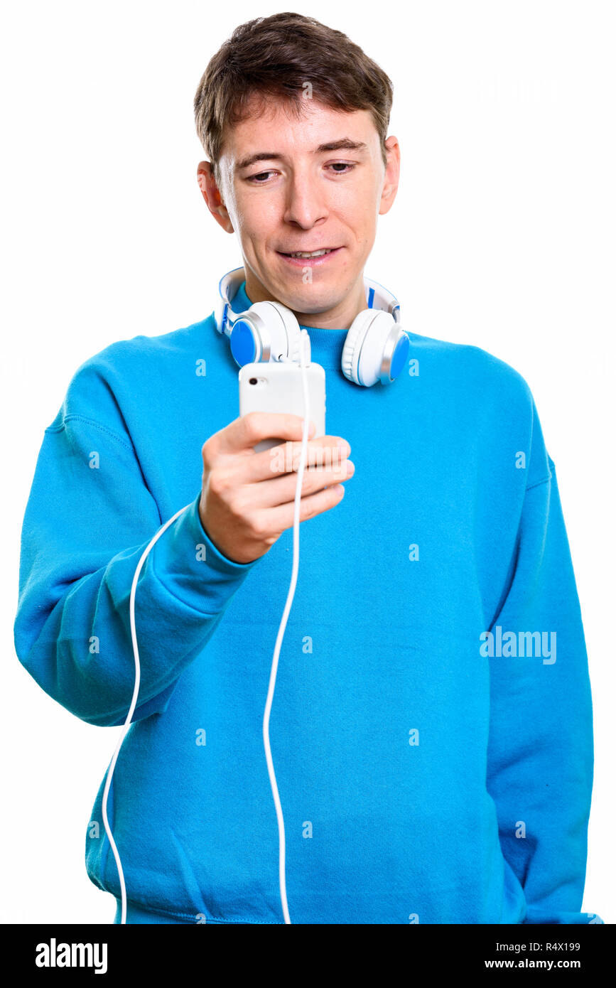 Studio shot of man wearing headphones around neck while holding  Stock Photo
