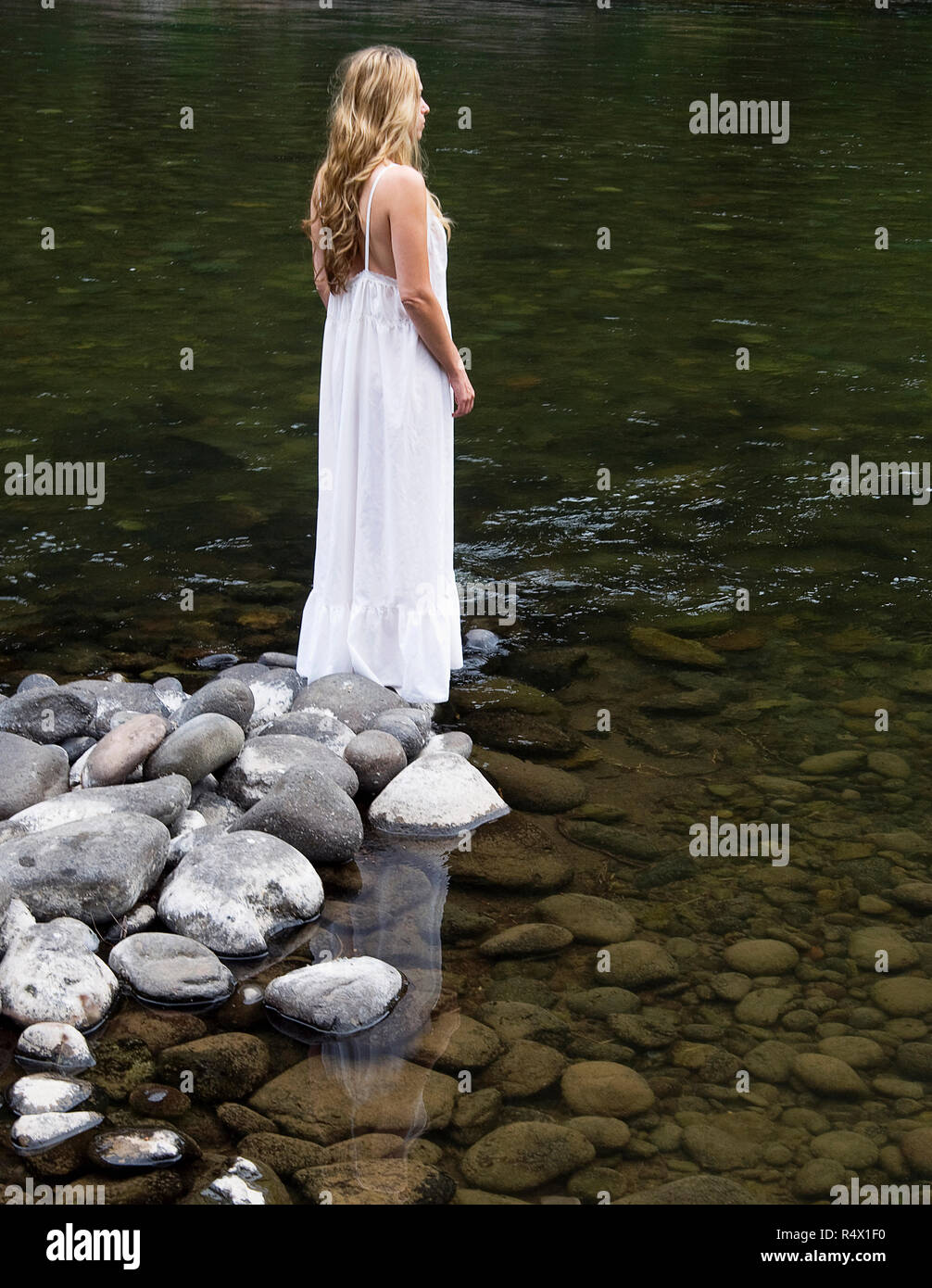 Woman standing by river hi-res stock photography and images - Alamy