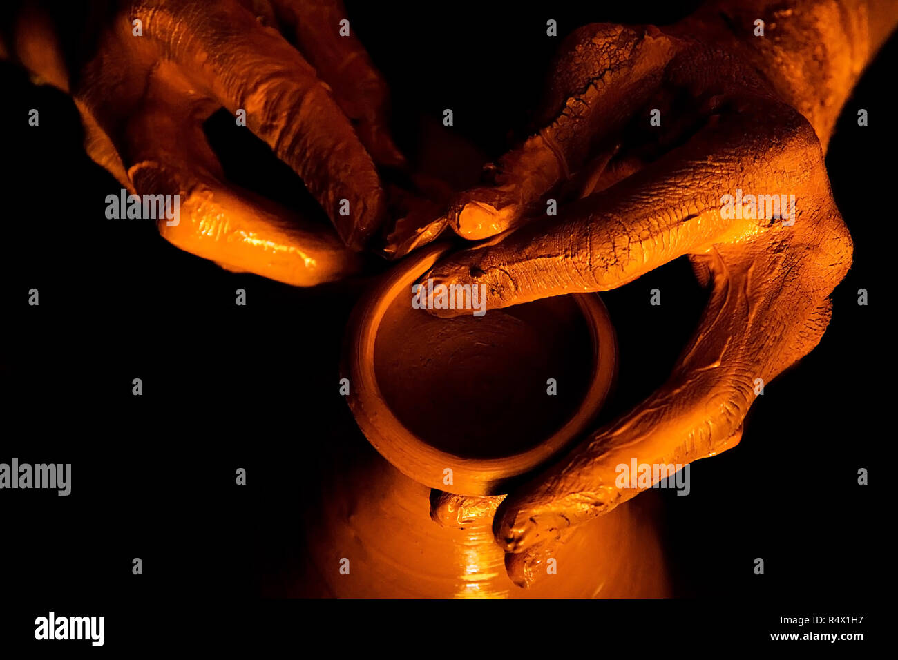 Closeup of potter sculpting a clay pot. Modeling clay closeup. Shows