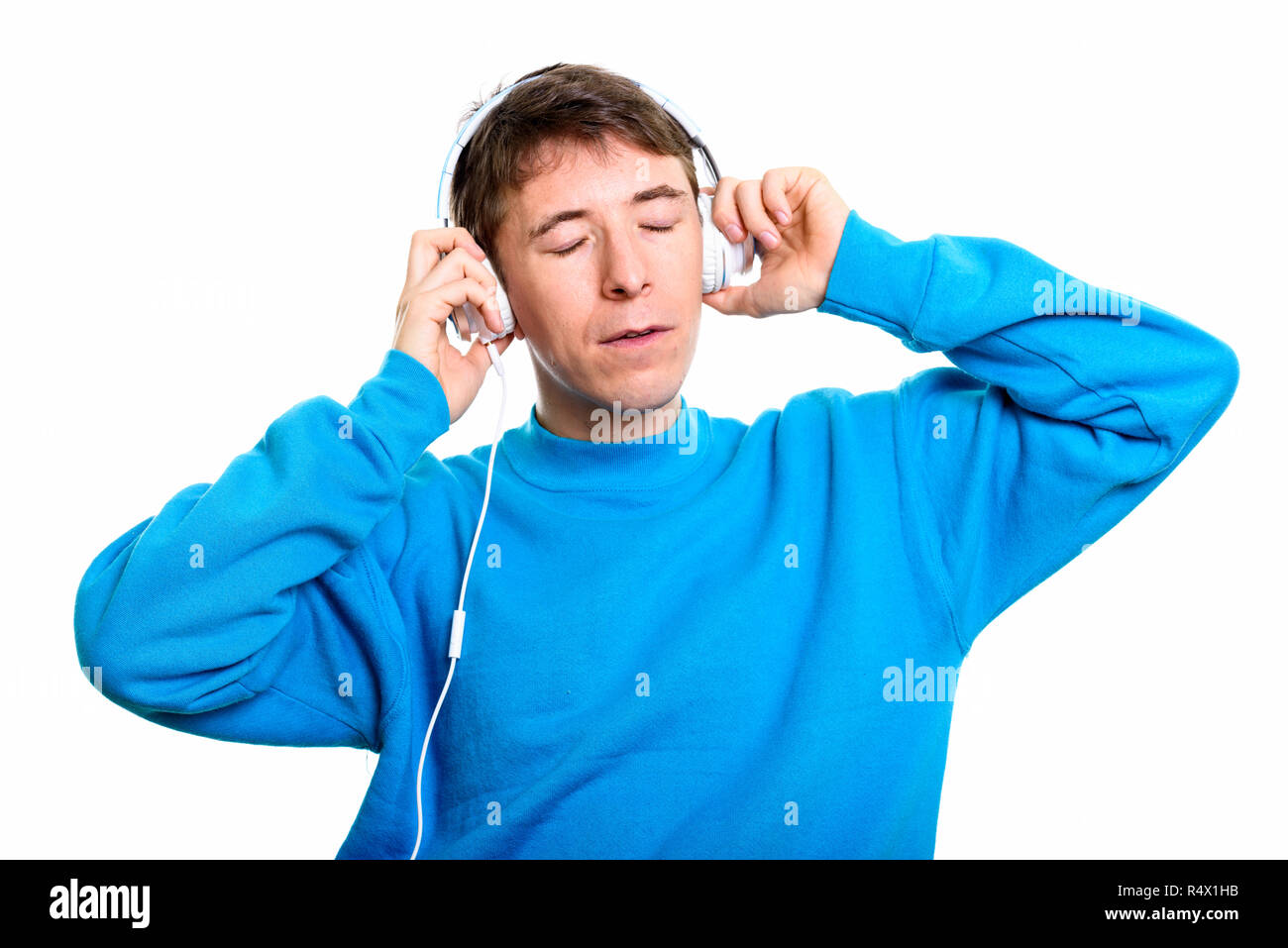 Studio shot of man listening to music with eyes closed Stock Photo