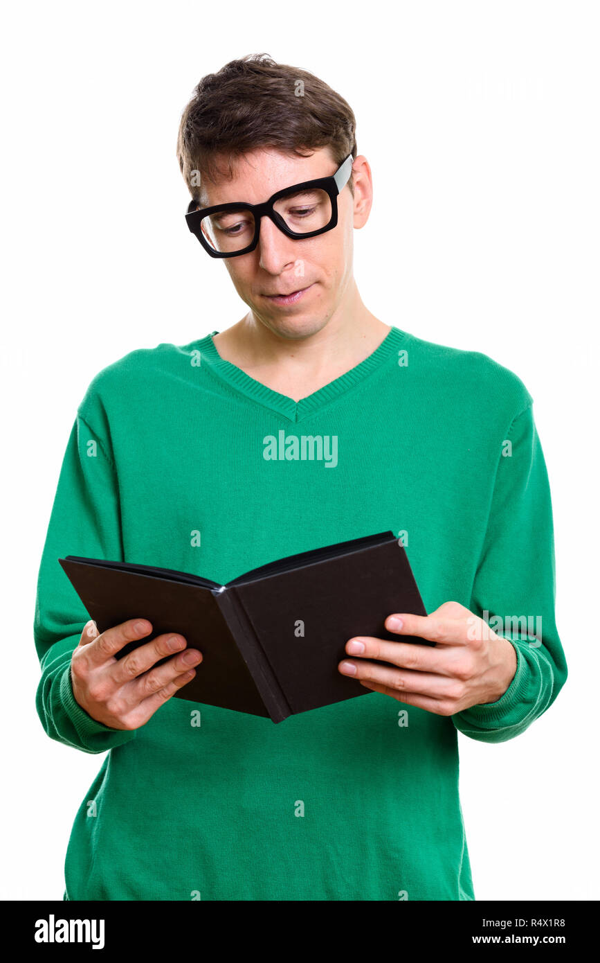 Studio shot of nerd student man reading book Stock Photo