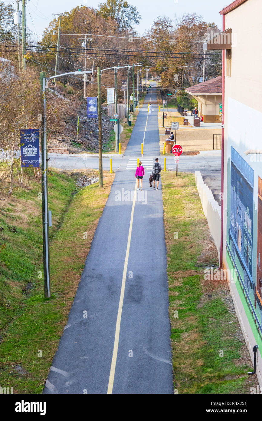 LINCOLNTON, NC, USA-11/25/18: A young couple with dog walk on a walking/bicycle path. Stock Photo