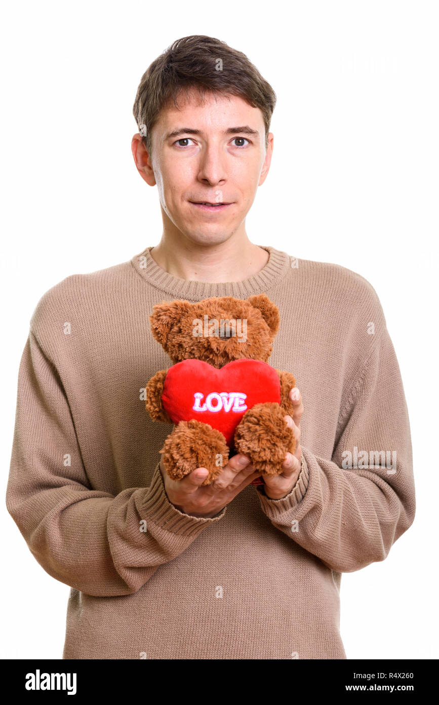 Studio shot of man holding teddy bear with heart and love sign Stock Photo