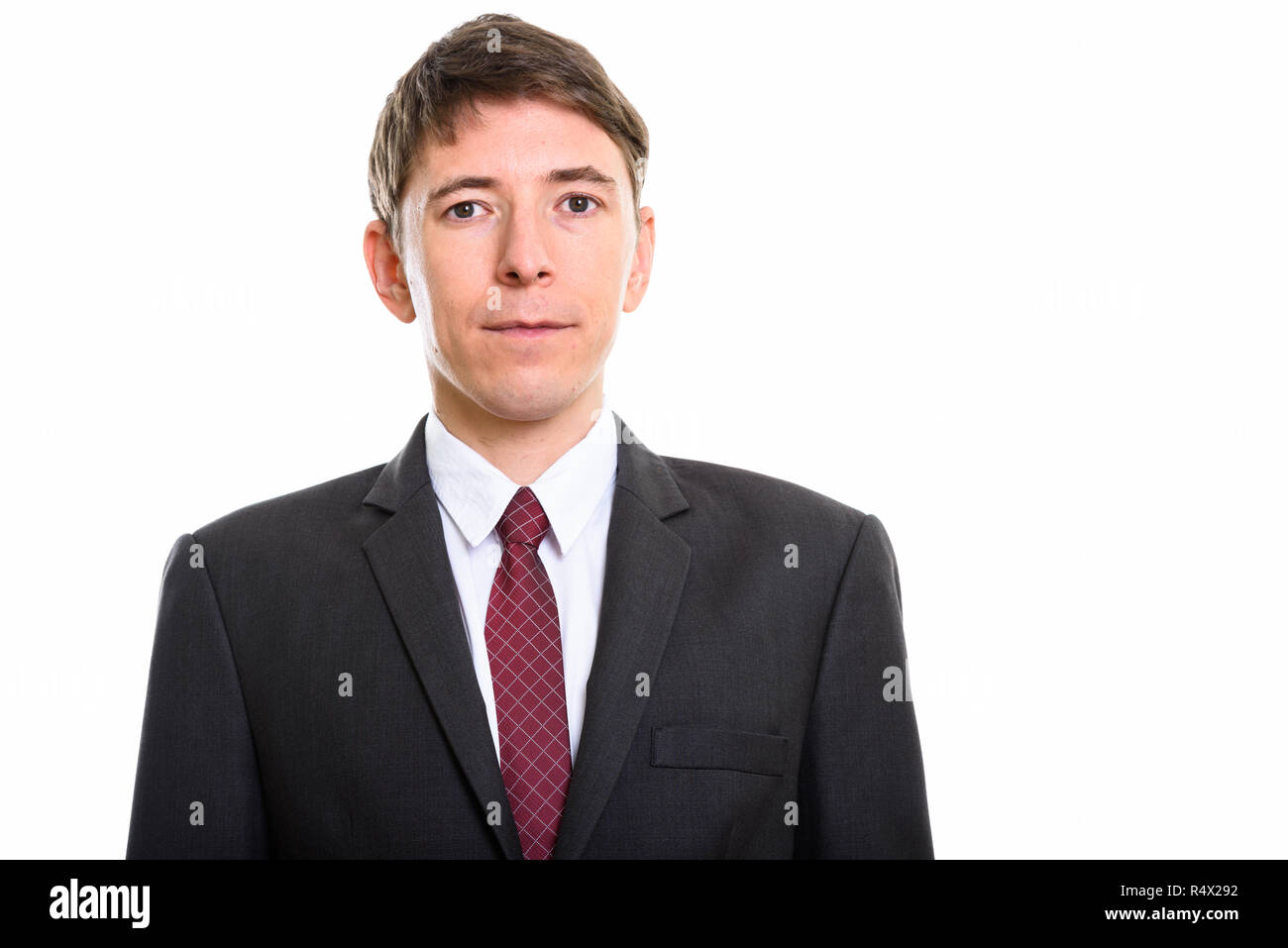 Studio portrait of businessman wearing suit and looking at camera Stock ...