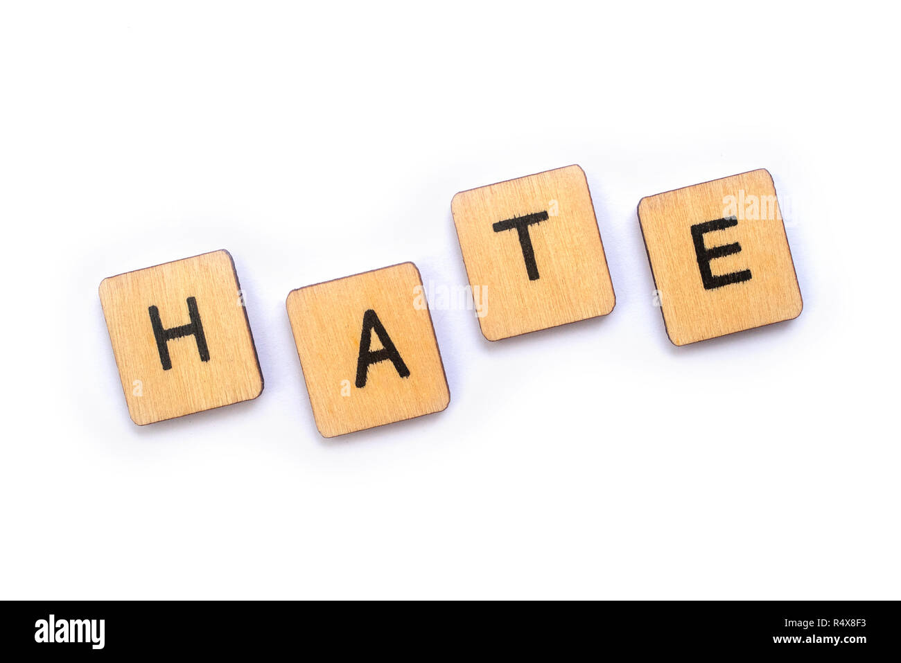 The word HATE, spelt with wooden letter tiles. Stock Photo