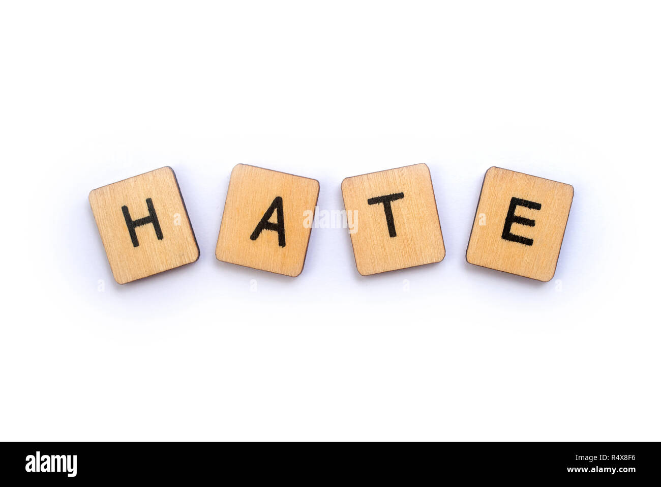 The word HATE, spelt with wooden letter tiles. Stock Photo