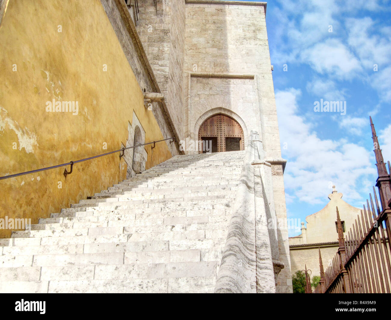 The entrance staircase and the pointed arch door of the Torre de Serranos (Serranos Gate) during a sunny clear day in Valencia, Spain Stock Photo