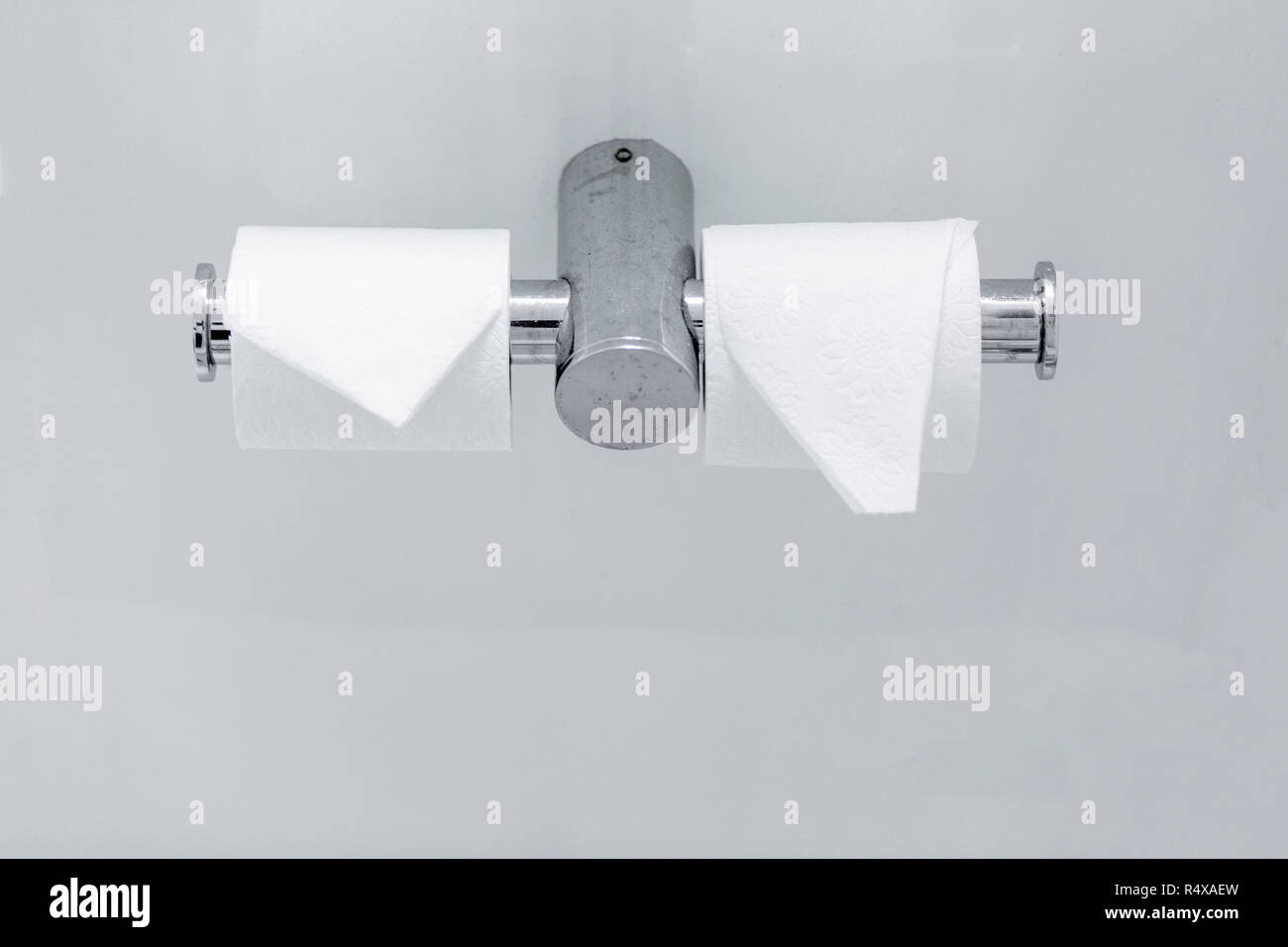 white toilet paper rolls and water valve Stock Photo