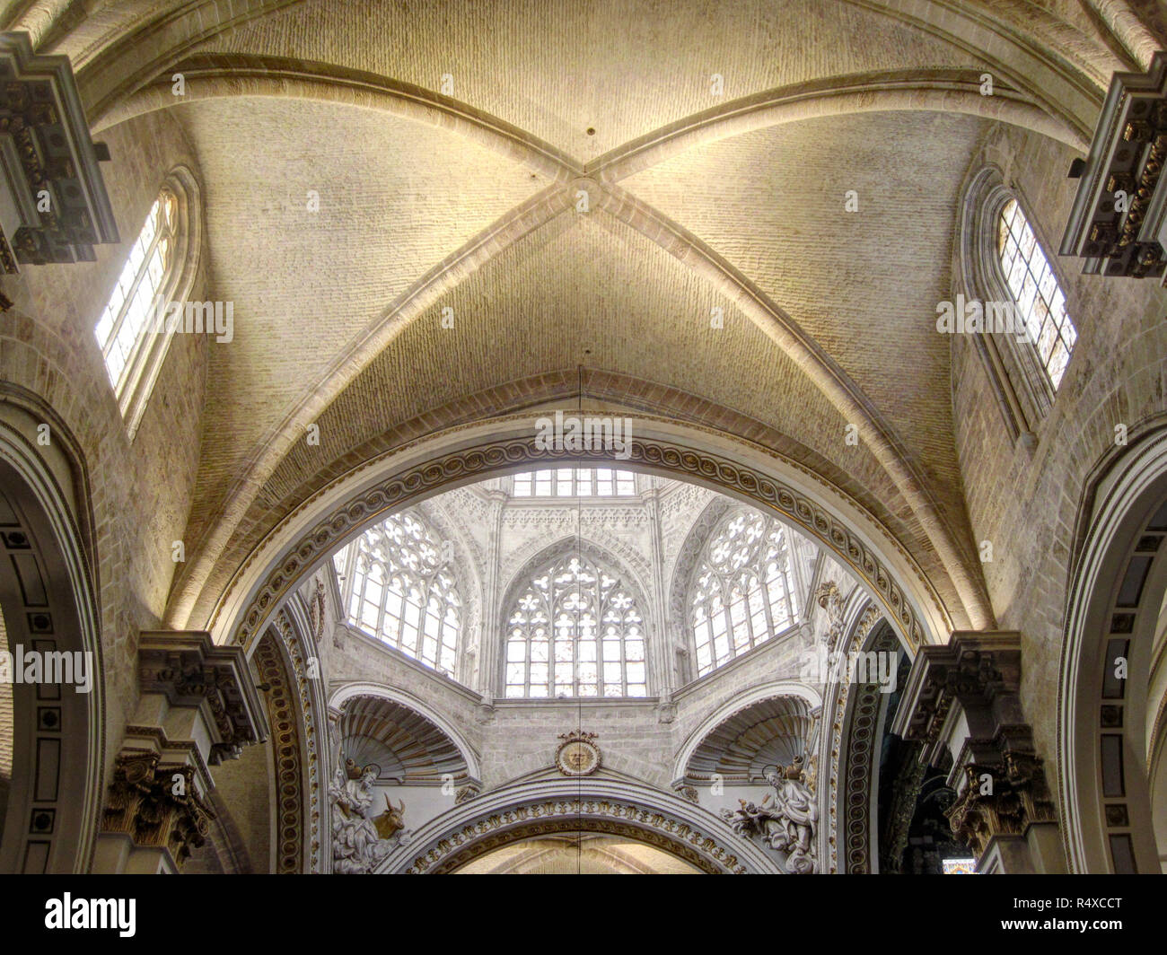 The main dome with stained glass windows and decorated pointed arches and the pointed vault in the gothic Saint Mary's Cathedral in Valencia, Spain Stock Photo