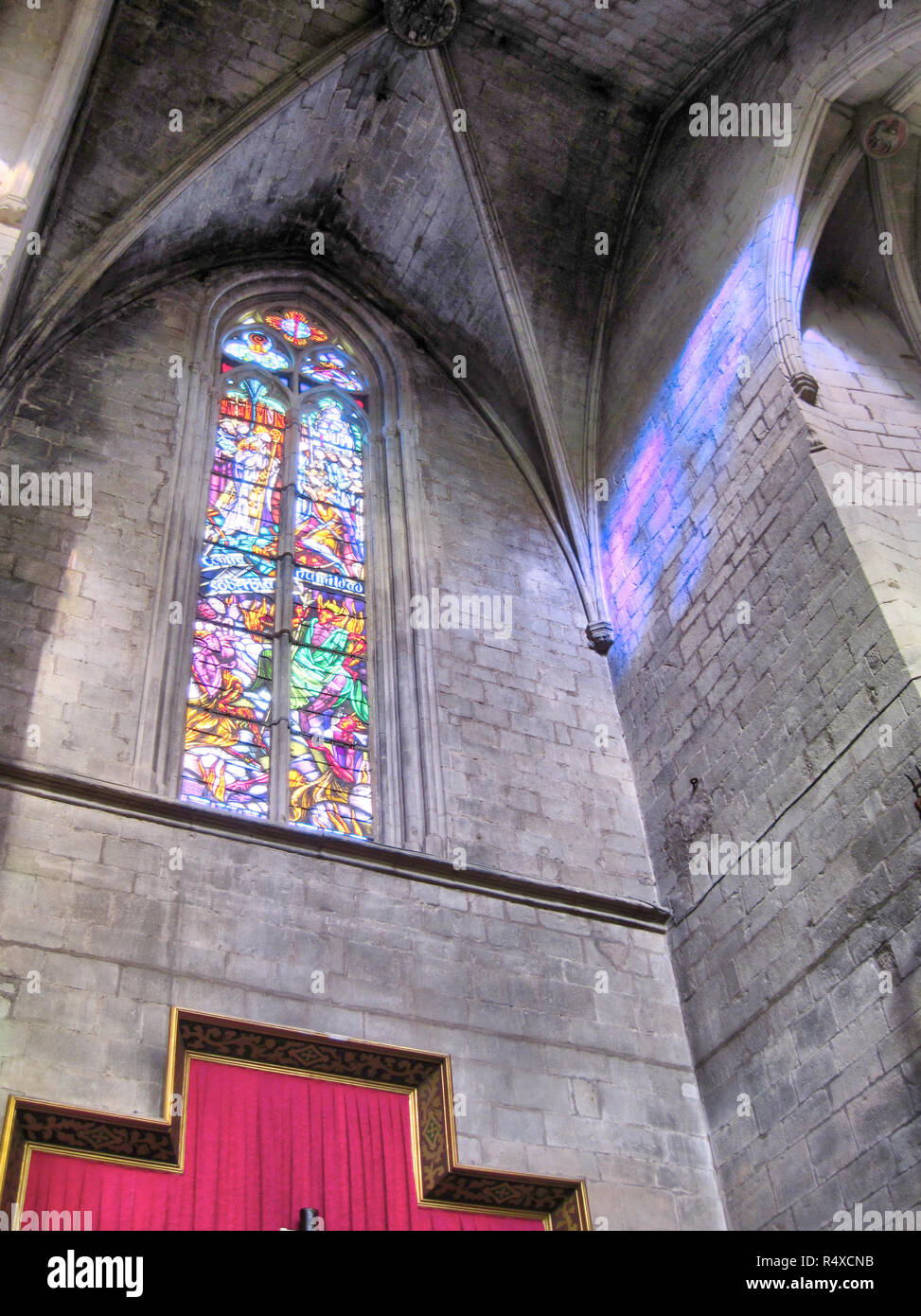 Stained glass window in the romanesque and gothic Collegiate Basilica