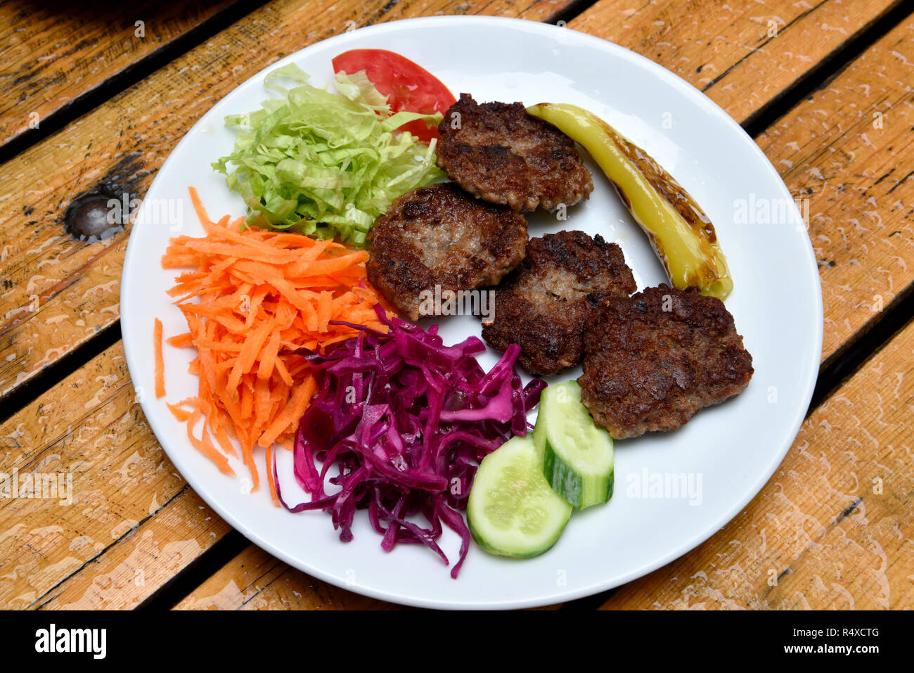 Plate of Akcaabat kofte meatballs with salad in the Black Sea region of Turkey. Stock Photo