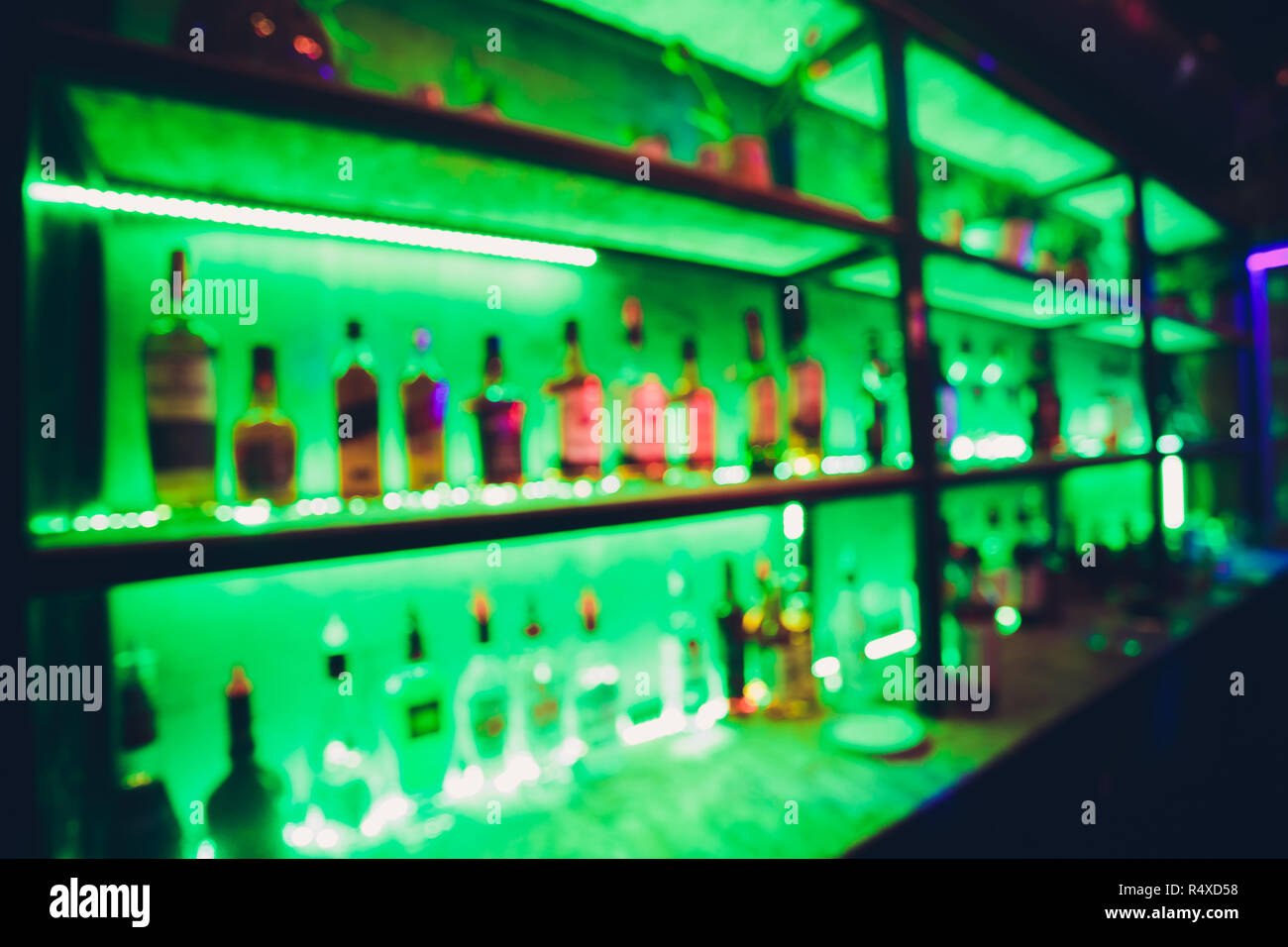 blur alcohol drink bottle at club pub or bar in dark party night background  Stock Photo - Alamy