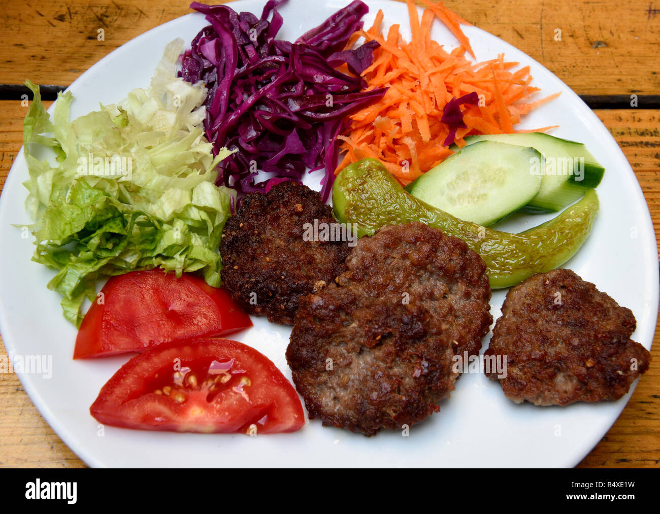 Plate of Akcaabat kofte meatballs with salad in the Black Sea region of Turkey. Stock Photo