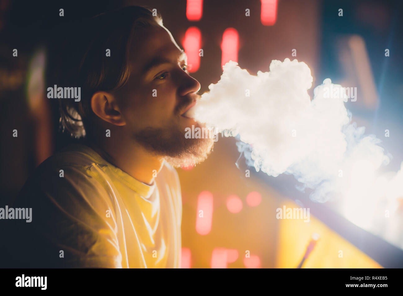 Young Man Smoking Shisha At Arabic Restaurant Man Exhaling Smoke