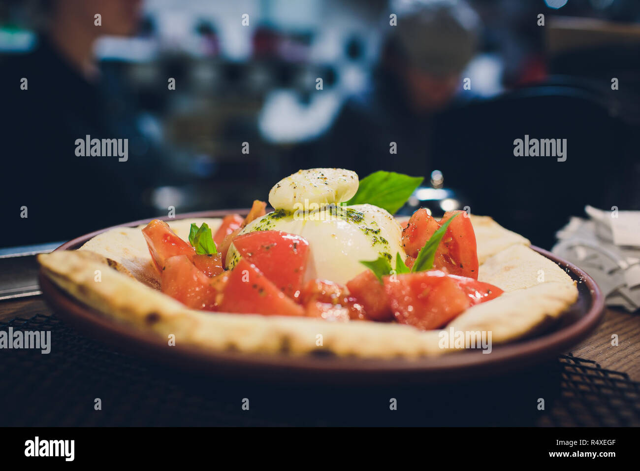 Turkish and Arabic Traditional Ramadan Pide with egg on top. Wood Background. Pizza Margherita is a typical Neapolitan, made with tomatoes, mozzarella, fresh basil, salt and extra virgin olive oil. Stock Photo