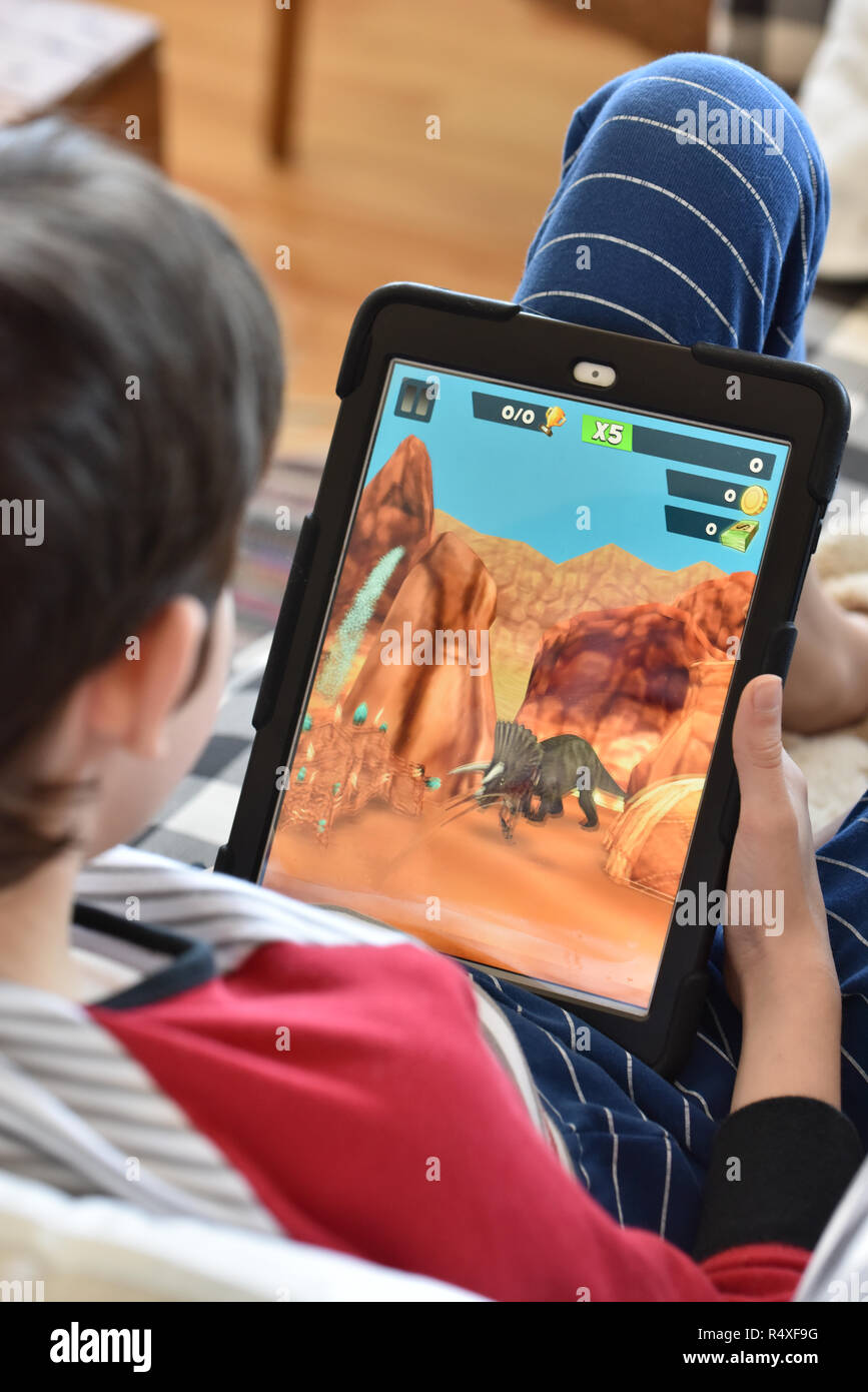 Boy playing games on Tablet Stock Photo