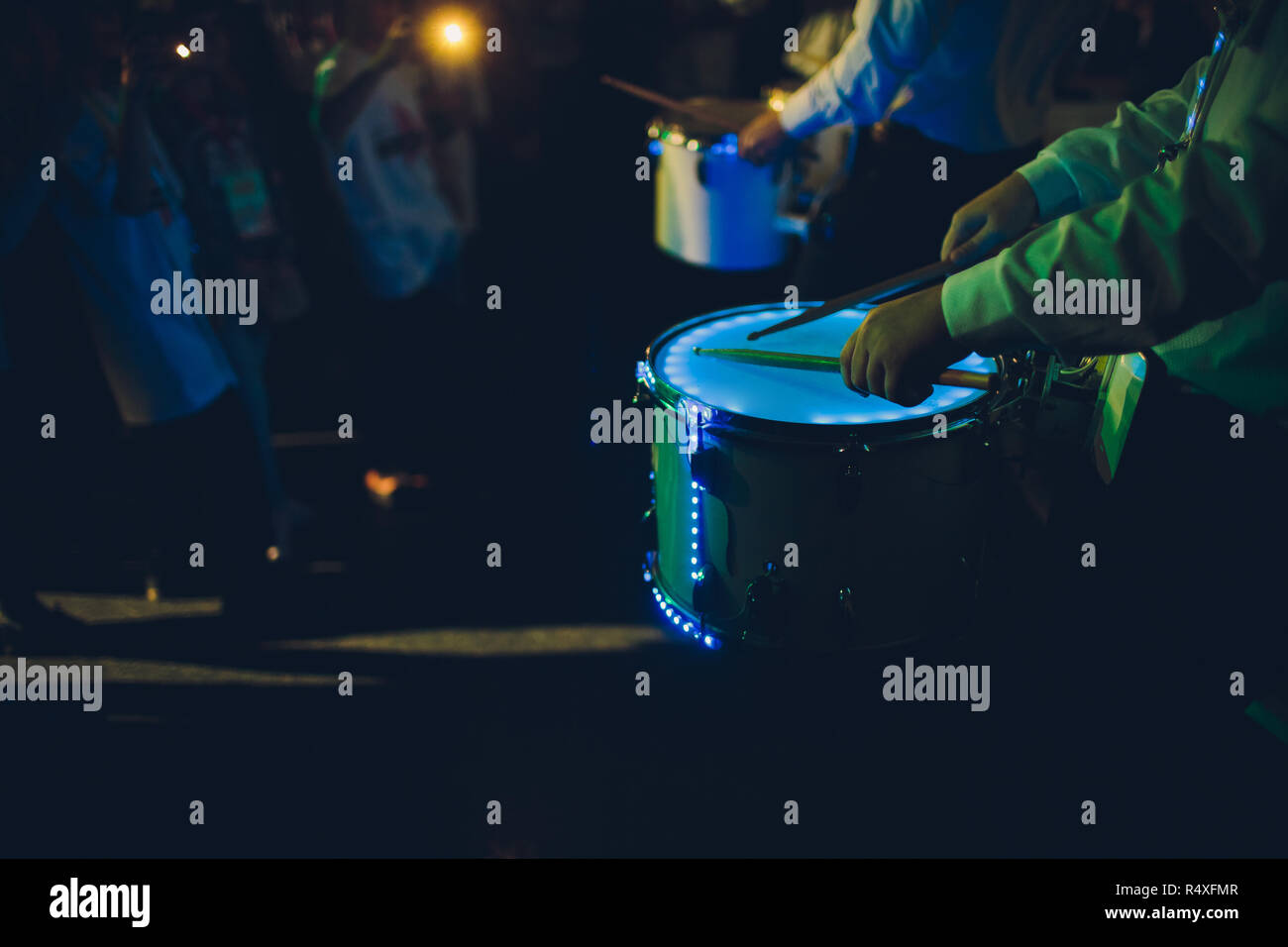 Drummer.The guy holding the drumsticks in his hand.Young man with