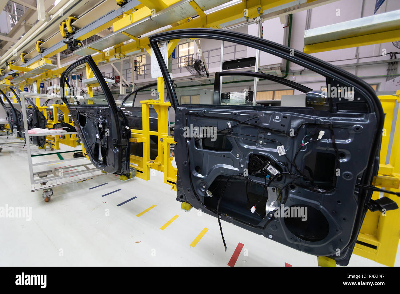 car door on conveyor. Robotic equipment makes Assembly of car. Modern