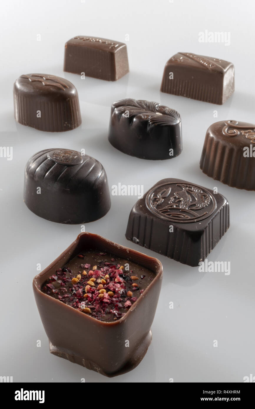filled chocolates plus flavors in front of the white background Stock