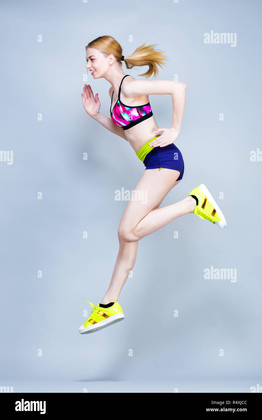 Young woman practices fitness exercises Stock Photo