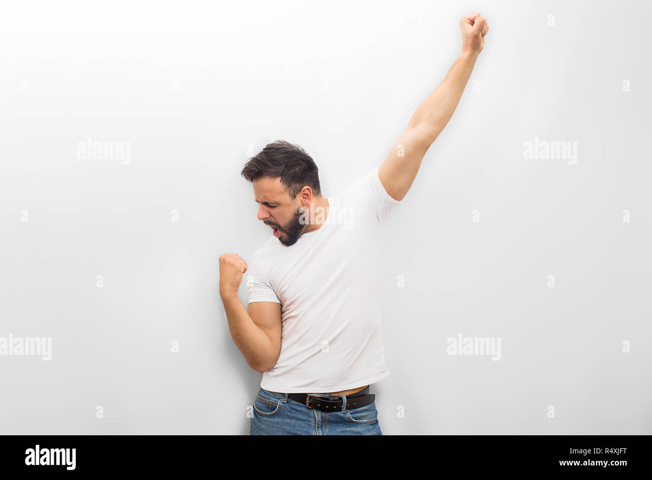 young muscular man in an expressive pose, throwing his hands up. Beautiful  muscles. extraordinary athletic body. Portrait on a gray background Stock  Photo | Adobe Stock