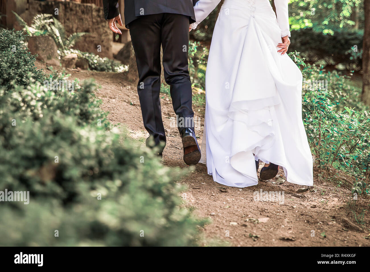 Image of Bride and groom legs walking away Stock Photo