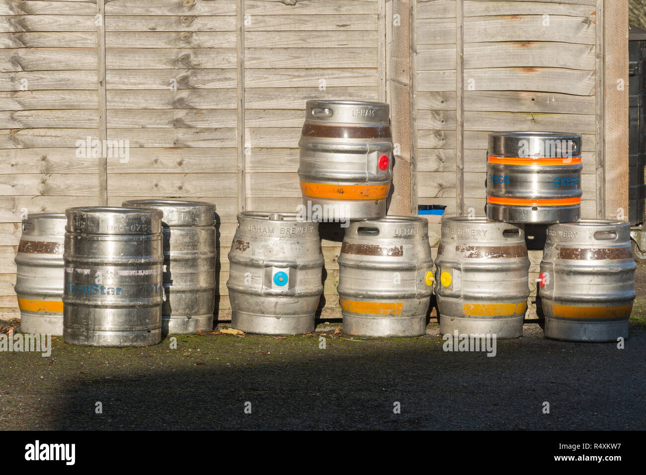 Beer barrels or kegs piled up outside a pub Stock Photo
