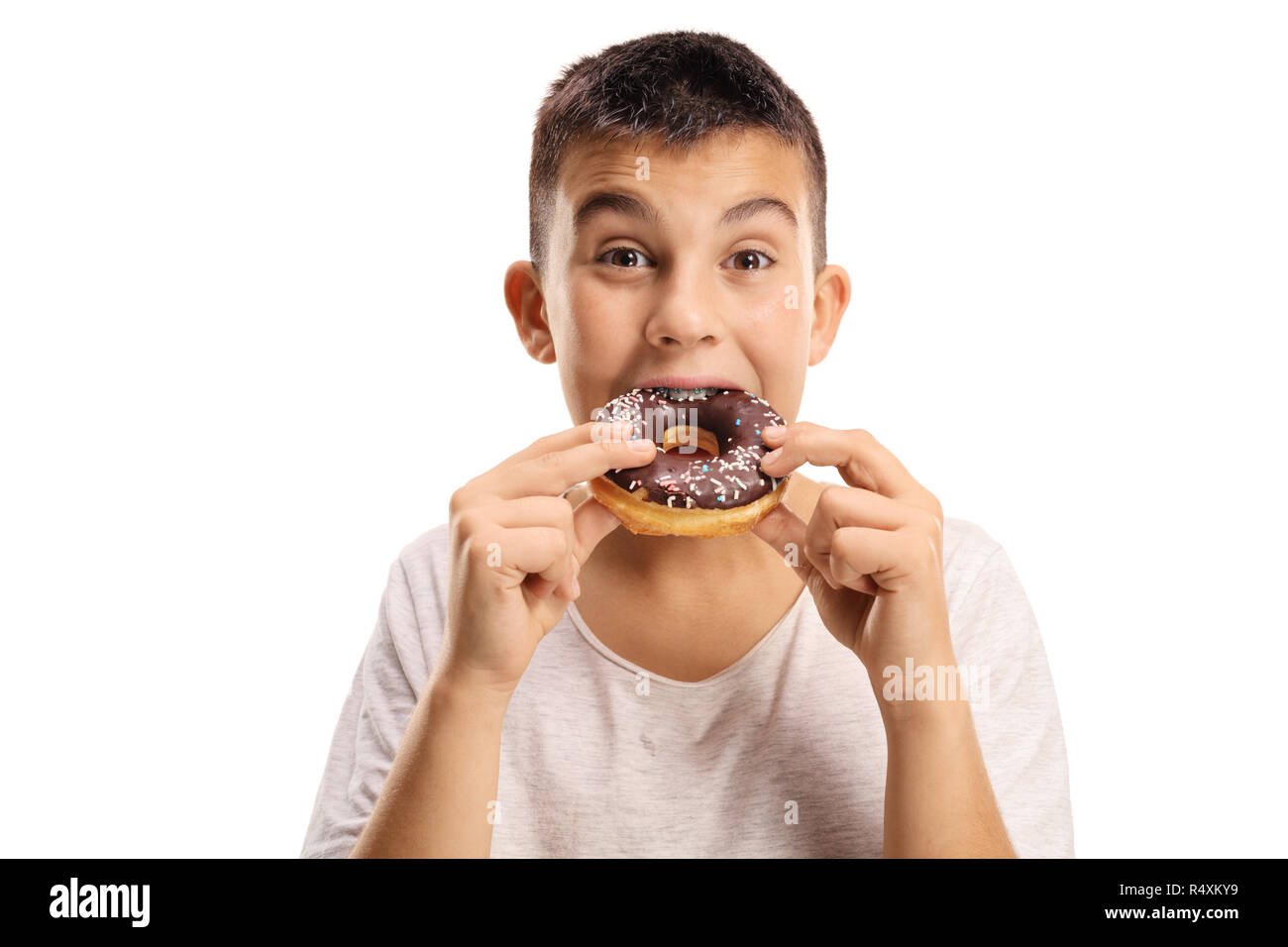 Young boy biting a donut isolated on white background Stock Photo