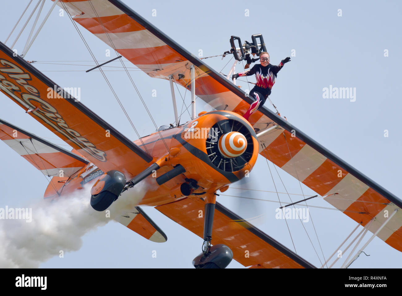 The Flying Circus, formerly Breitling, Wingwalkers wingwalking display team flying at an airshow. Boeing Stearman biplane plane with girl on wing Stock Photo