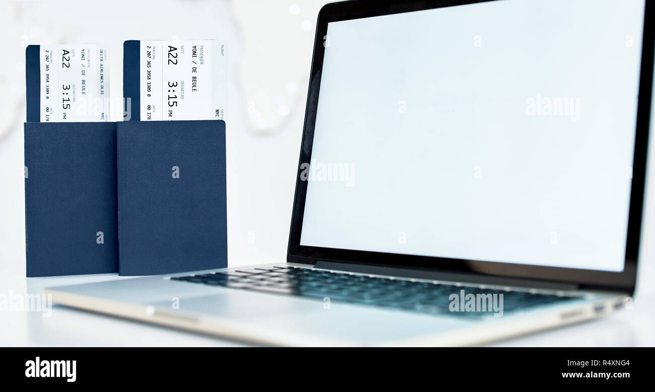 Travel tickets with passport near the laptop Stock Photo